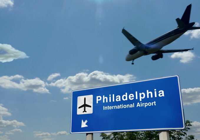 Airplane silhouette landing in Philadelphia, Pennsylvania, USA. City arrival with international airport direction signboard and blue sky. Travel, trip and transport concept 3d illustration.